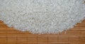 Raw white rice on the wooden mat