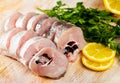 Raw whiting fish steaks with lemon and greens