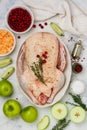 Raw whole duck for baking with apples, cranberries, sauerkraut and spices