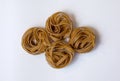 Raw whole grain brown pasta Tagliatelle Royalty Free Stock Photo