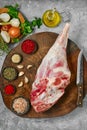 Raw whole lamb leg chump on with ingredients, top view Royalty Free Stock Photo