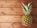 Raw whole pineapple on wooden surface table Royalty Free Stock Photo