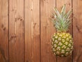 Raw whole pineapple on wooden surface table Royalty Free Stock Photo