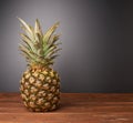 Raw whole pineapple on wooden surface table Royalty Free Stock Photo