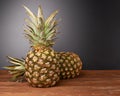 Raw whole pineapple on wooden surface table Royalty Free Stock Photo