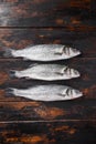 Raw whole seabass on old fisherman wooden table top view