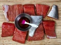 Raw Wild Pacific Salmon fish fillet on bamboo wood board with stainless steel bowl filled with maple syrup plus brush Royalty Free Stock Photo