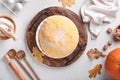 Raw yeast dough with pumpkin in white bowl covered with towel on the floured kitchen table, recipe idea. Concept home baking bread Royalty Free Stock Photo