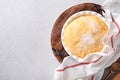 Raw yeast dough with pumpkin in white bowl covered with towel on the floured kitchen table, recipe idea. Concept home baking bread Royalty Free Stock Photo