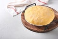 Raw yeast dough with pumpkin in white bowl covered with towel on the floured kitchen table, recipe idea. Concept home baking bread Royalty Free Stock Photo