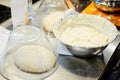 Raw yeast dough under glass bowl Royalty Free Stock Photo
