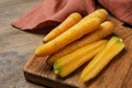 Raw yellow carrots on wooden board