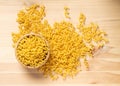 Raw yellow cavatappi pasta on wood table background Royalty Free Stock Photo