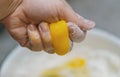 The raw yellow egg yolk is crushed in the hand and runs down the finger. Manual pressing of a fresh chicken egg. A woman crushes a