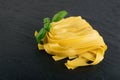 Raw yellow italian pasta pappardelle, fettuccine or tagliatelle