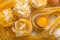 Raw yellow italian pasta pappardelle, fettuccine or tagliatelle