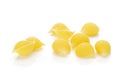 Raw yellow pasta conchiglie isolated on white Royalty Free Stock Photo