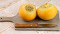 Raw yellow turnips with knife on a table