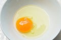 Raw yolk and white egg cracked from shell in cup Royalty Free Stock Photo