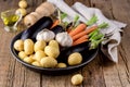 Raw Young Potatoes Carrot Garlic and Eggplant on Black Plate Variety of Raw Vegetables ready to Cook Fresh Natural Vegetables