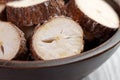 Raw yucca (cassava) sliced root in wooden bowl on a kitchen rustic table Royalty Free Stock Photo
