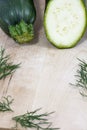 Raw zucchini with fennel on wooden background Royalty Free Stock Photo