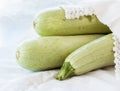 Raw on zucchini white background Royalty Free Stock Photo