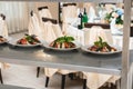 Raws of tomatoes mozzarella salad in white plate with homemade chees and ingredients on a metal rack Royalty Free Stock Photo