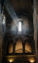 .a ray of light breaks out from a high window in an ancient temple