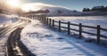 A Ray of Sunlight Brightens a Roadside Wooden Fence in a Grey, Snow-Covered Winter Scene