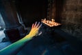 ray of sunlight fell on the hand of a believer in the interior of a Catholic church, decomposed into a rainbow spectrum of Royalty Free Stock Photo
