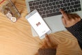 Rayong, THAILAND, May 20, 2019 : A woman hand holding gmail app logo Social networks icons showing on Apple iPhone 6 plus screen