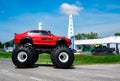 Red BMW car 4x4 bigfoot parked on asphalt road in Air Race 1 World Cup Thailand 2017 at U-Tapao Naval Air Base