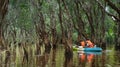 A group of tourists enjoying the sets off for a guided kayak tour in the ancient mangrove forest, Thailand.