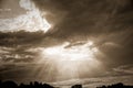 Rays of bright sun peep out from behind dark clouds, sun break after storm Royalty Free Stock Photo