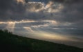 Rays of light through the clouds in Panoramic view of Ngorongoro Conservation Area at sunrise from the mountainside. Tanzania, Royalty Free Stock Photo