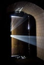 Rays of light coming from behind old rusty door of abandoned building