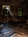 Rays of light filter through the window of a room of an abandoned madhouse Royalty Free Stock Photo