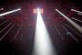 Rays of light from searchlights, directed from the top down in the hall in preparation to the show boxing Royalty Free Stock Photo