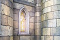 rays of morning sun penetrate through a beautiful stained glass window of a stone castle or cathedral, selective focus Royalty Free Stock Photo