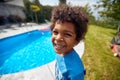 Rays of Poolside Joy: Afro-American Boy\'s Infectious Laughter Lights Up the Scene Royalty Free Stock Photo