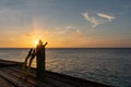 Rays of a setting sun behind snorkel gear- fin, tank, mask, and snorkel with copy space Royalty Free Stock Photo