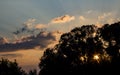 The rays of the setting sun in the blue sky with clouds Royalty Free Stock Photo