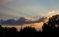 The rays of the setting sun in the blue sky with clouds Royalty Free Stock Photo