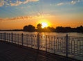The rays of the setting sun on the embankment of the river Kuban