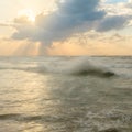 The rays of the sun breaking through the clouds. Quiet beautiful golden sunset on the sea. Summer nature background Royalty Free Stock Photo