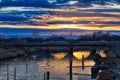 Sunset on river under ancient railway bridge