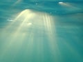Rays of Sun light shine underwater Royalty Free Stock Photo