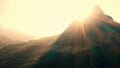 Rays of sunlight above mountain peak. Royalty Free Stock Photo