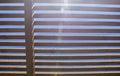 Rays of sunlight filtering through a wooden pergola